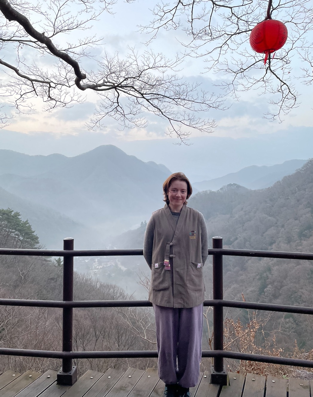 A NYU student in South Korea, standing in front of a valley.